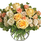 A beautiful combination of assorted fresh roses and miniature roses in soft yellow, white, and pink or peach tones, arranged with fresh greenery in a glass bowl. A thoughtful gift for any occasion and a wonderful centerpiece, too!  Professional florist delivery in the USA and Canada.
