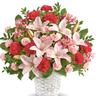 Express your deepest sympathy with this lovely display of fresh lilies, carnations, alstroemeria, and greens in pretty shades of pink. Designed and delivered in a wicker basket. Soft, feminine, and full of beauty. USA and Canada florist delivery.