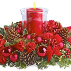 Make their holiday table glow with this beautiful Christmas centerpiece featuring crimson blossoms and ornament balls, pine cones, berries, and winter greens crowned with a festive pillar candle in glass. Lovely! Available in most areas after Thanksgiving through December. Professional florist design and delivery in the USA and Canada.